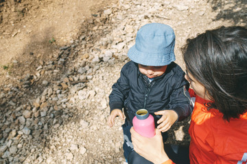 Mother with Son Holding Bottle