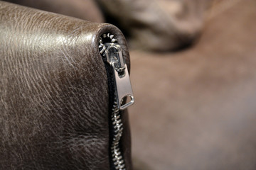 Brown Leather Upholstery and zipper of  Sofa