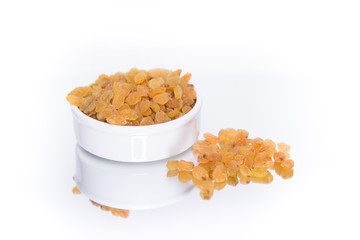 Raisins in a bowl isolated with reflection