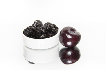 Prunes and a plum isolated with reflection