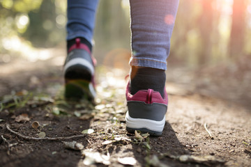 a girl walking through a forest