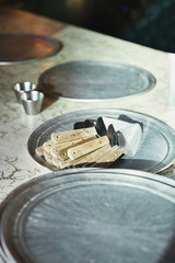 pizza servers lying on metal tray on marble table at restaurant kitchen