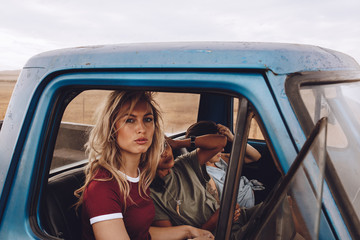 Female friends on road trip traveling by a car © Jacob Lund