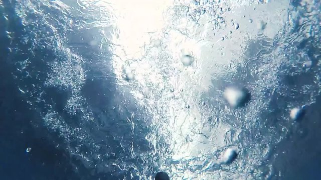 Action camera view submerged in swimming pool in slow motion.
