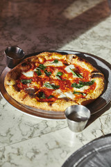 close-up shot of delicious pizza margherita on marble tabletop