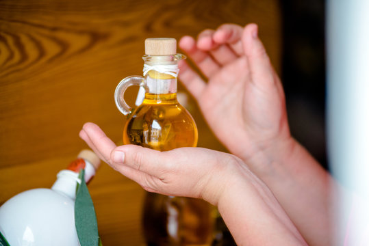     Girl holding a bottle of olive oil 