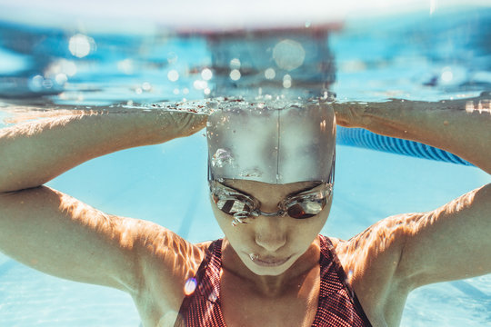 Woman swimmer inside swimming pool