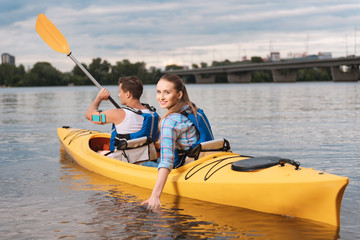 Unbelievable vacation. Smiling woman feeling unbelievable spending her vacation near the river with husband