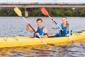 River adventure. Beaming appealing man and woman feeling memorable while having nice river adventure
