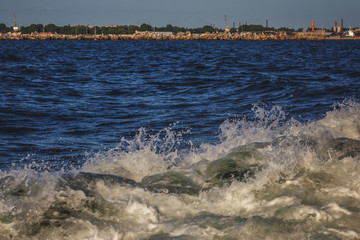 water spray forms on the side of the ship