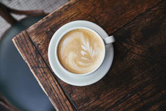 top view of cup of fresh coffee on rustic wooden table