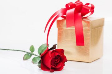 Valentine red roses and gift on white background.