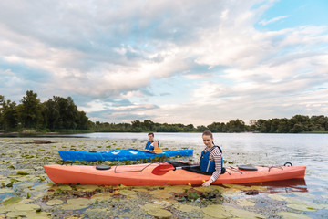Beautiful landscape. Loving beautiful couple enjoying beautiful landscape while rowing in canoe