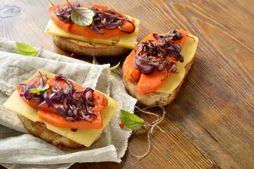 Bruschetta with roasted pumpkin, cheese and fried onions, copy space