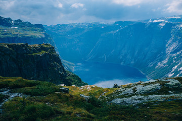 Fototapeta na wymiar Unreal Norway landscape. Trolltunga hiking route. Nobody. Dramatic view before rain. Summer