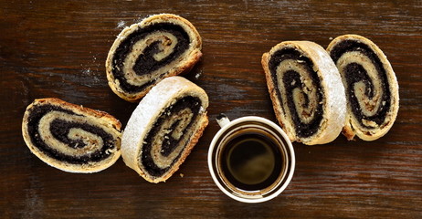 Poppy seed roll slices sprinkled with powdered sugar, top view