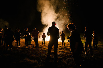 Group of people around a large bonfire