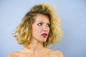 face of a pretty girl with curly hair and red lips closeup