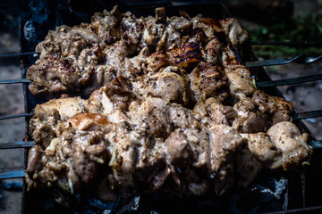Grilled kebab cooking on metal skewers (grill).