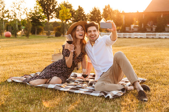 Young cute loving couple take a selfie by mobile phone.