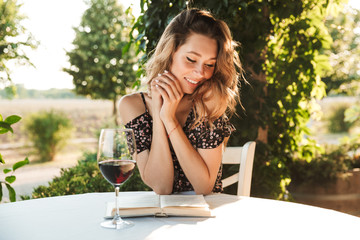 Beautiful young woman drinking wine.