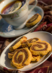 Cup of tea with chocolate and vanilla butter cookies