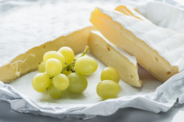 close up view of brie cheese and grape