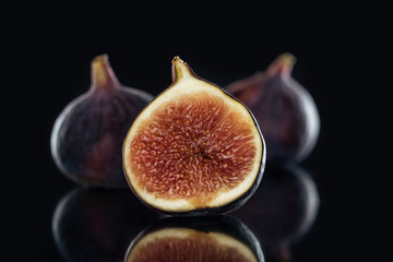 close up view of fresh figs on black background