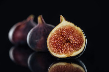 close up view of fresh figs on black background