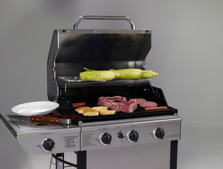 Gas grill with meat and corn