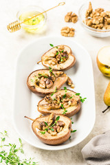 healthy vegan dessert, baked pears with nuts and honey.Selective focus, space for text.