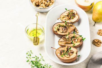 healthy vegan dessert, baked pears with nuts and honey.Selective focus, space for text.