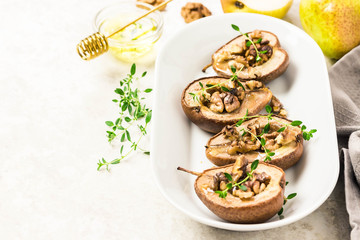healthy vegan dessert, baked pears with nuts and honey.Selective focus, space for text.