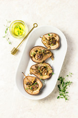 healthy vegan dessert, baked pears with nuts and honey. Top view,space for text.