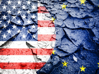 Trade war concept, USA flag against European flag, on dry cracked earth background