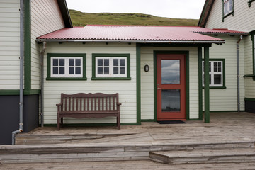Bench on the terrace in front of a traditional Icelandic house
