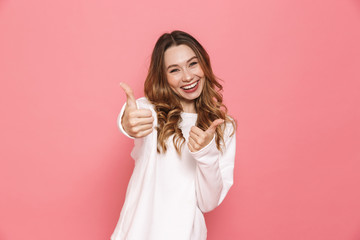 Portrait of a lovely young casual girl showing thumbs up