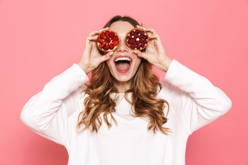 Portrait of an excited young woman showing pastry
