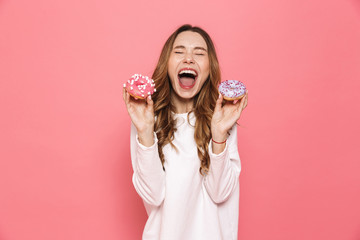 Portrait of an excited young woman showing pastry