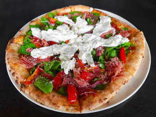 Wood-fired oven pizza with parma ham and burrata cheese