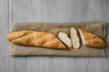 Sliced bread on wooden background. Bread slices and crumbs viewed from above. Top view