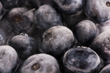 Ice cube with blueberries isolated on white