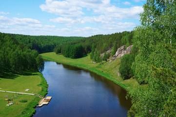 Fototapeta na wymiar River with rocks and green meadows