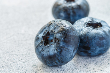 Fresh blueberries with water drops on a light surface close-up. . Antioxidant, organic superfood . The concept of healthy and dietary food
