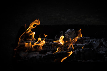 fiery flame on a black background with copy space. Background, texture