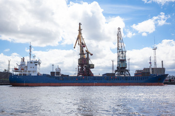 Fototapeta premium large cargo ship in port during unloading