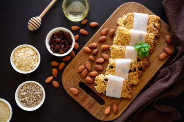 Super food breakfast bars with oats,sesame, sunflower seeds, honey and nuts on brown wooden background. Top view. Flat lay. Healthy eating concept