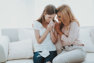 Woman Comforts Unhappy Teenage Daughter at Home.