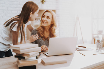 Mother and Daughter Watching into Laptop at Home.