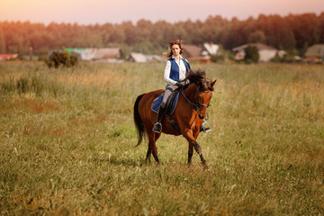 Young woman jockey gallop brown horse strolling across forest.